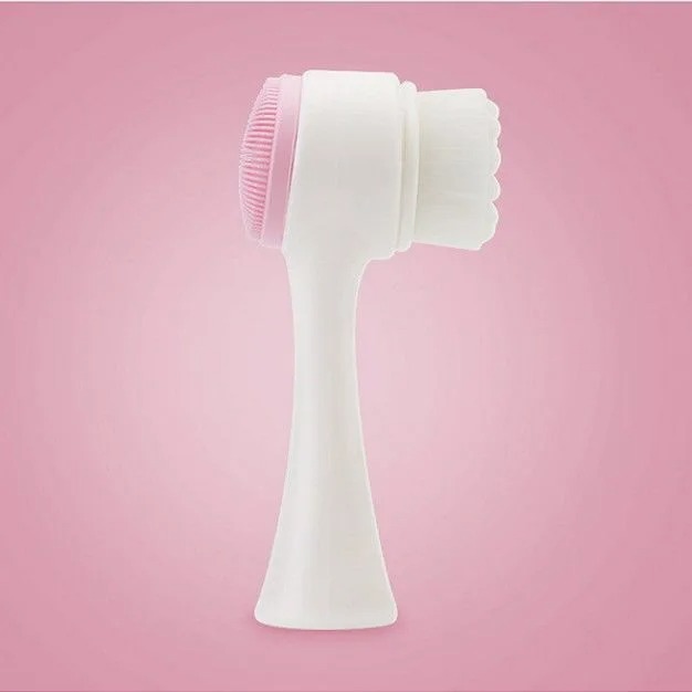Double-sided silicone facial cleansing brush with soft bristles and pink exfoliating nubs